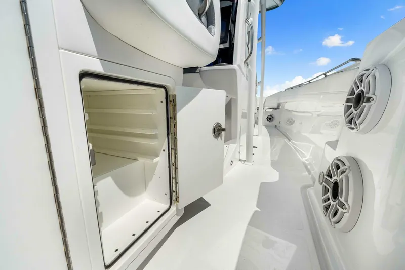  Yacht Photos Pics 2021 Nor-Tech 390 SS boat interior with open storage compartment and speakers.