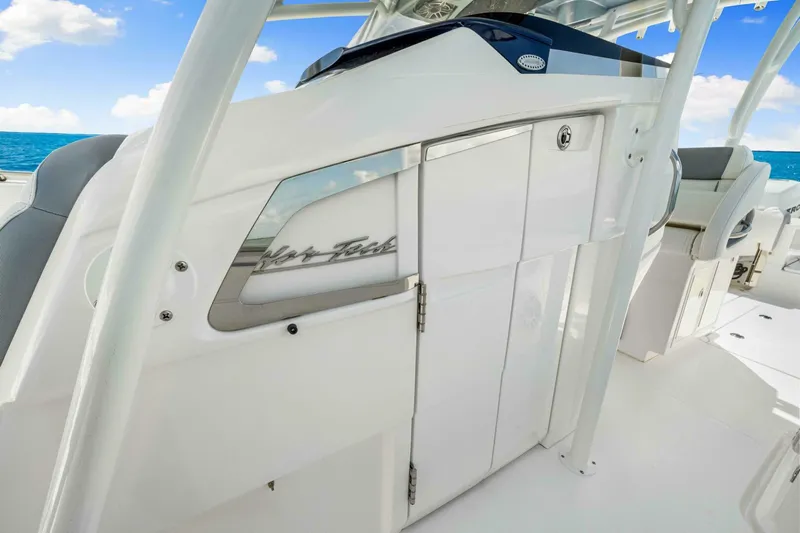  Yacht Photos Pics 2021 Nor-Tech 390 SS boat interior with sleek white cabinetry and ocean view.