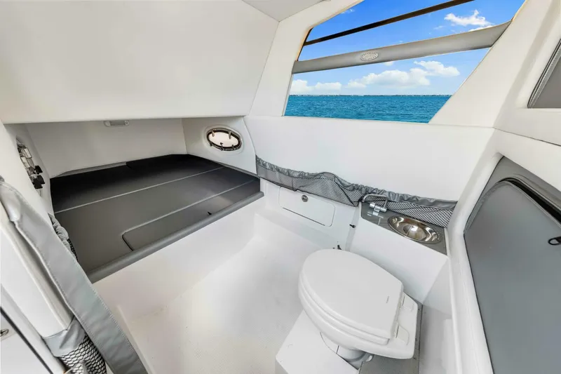  Yacht Photos Pics 2021 Nor-Tech 390 SS cabin interior with bed, toilet, and ocean view.
