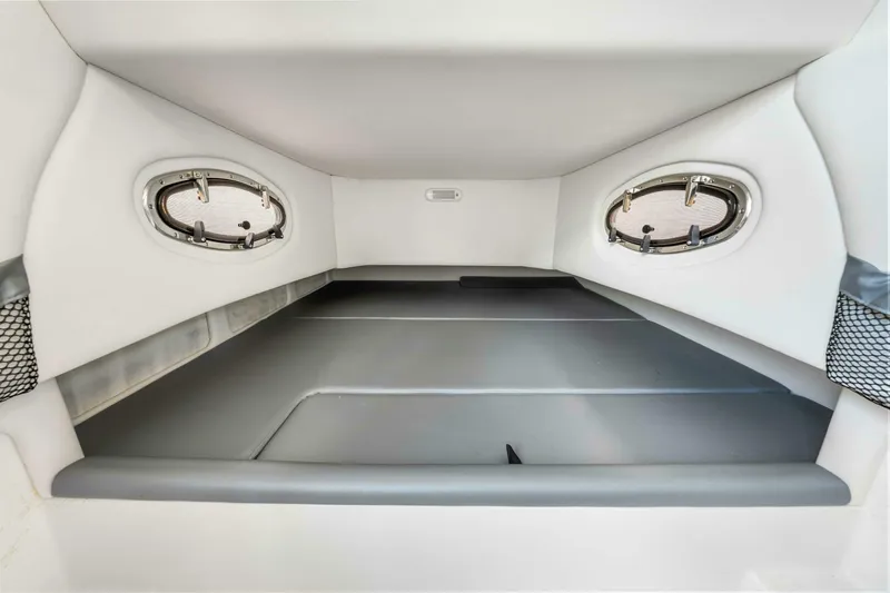  Yacht Photos Pics 2021 Nor-Tech 390 SS cabin interior with portholes and cushioned seating.