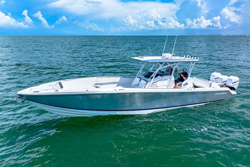  Yacht Photos Pics 2021 Nor-Tech 390 SS boat cruising on open water under a clear blue sky.