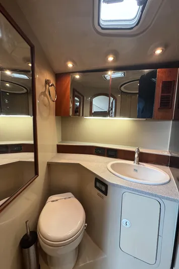 Lime Of Coconut Yacht Photos Pics 2006 Rampage 38 Express yacht bathroom with sink, toilet, mirror, and overhead lighting.