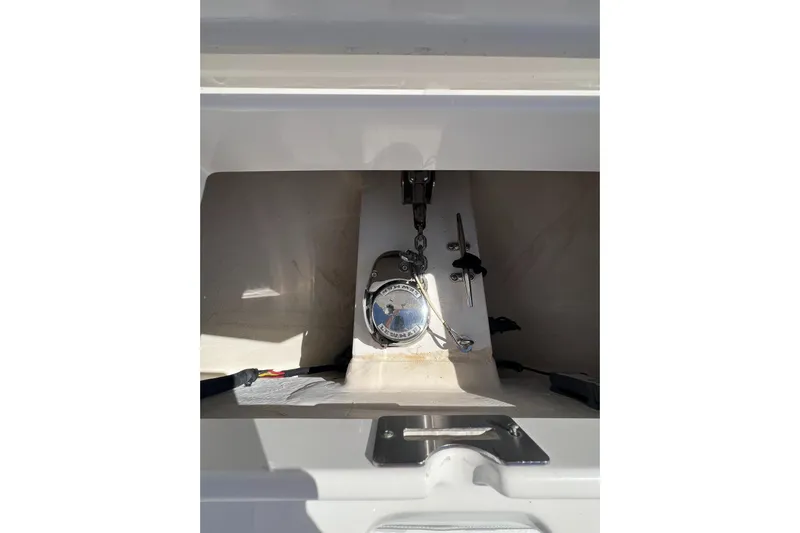 No Name Yacht Photos Pics 2016 Regulator 34 Center Console storage compartment with equipment and wiring.