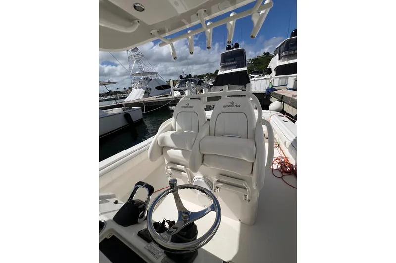 No Name Yacht Photos Pics 2016 Regulator 34 Center Console boat interior with helm and seating at marina.