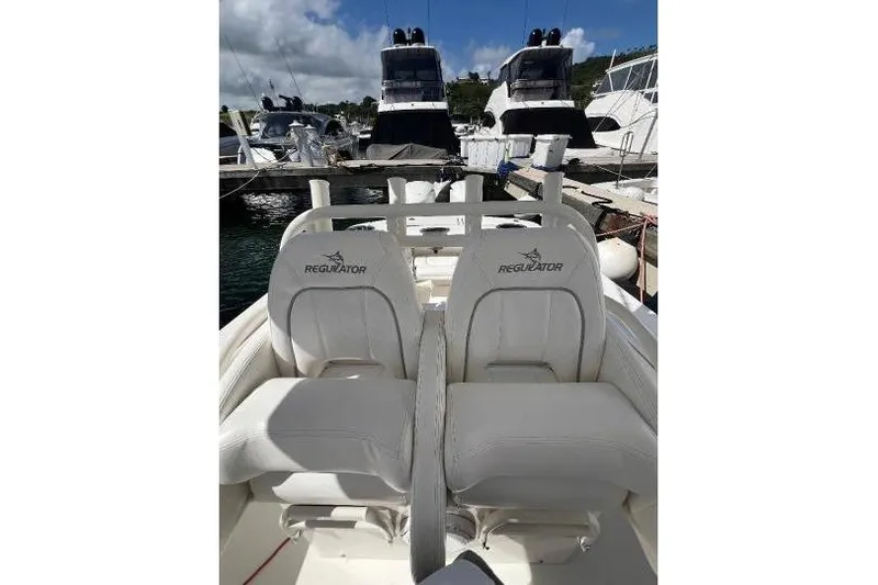 No Name Yacht Photos Pics 2016 Regulator 34 Center Console boat with white seating at a marina.