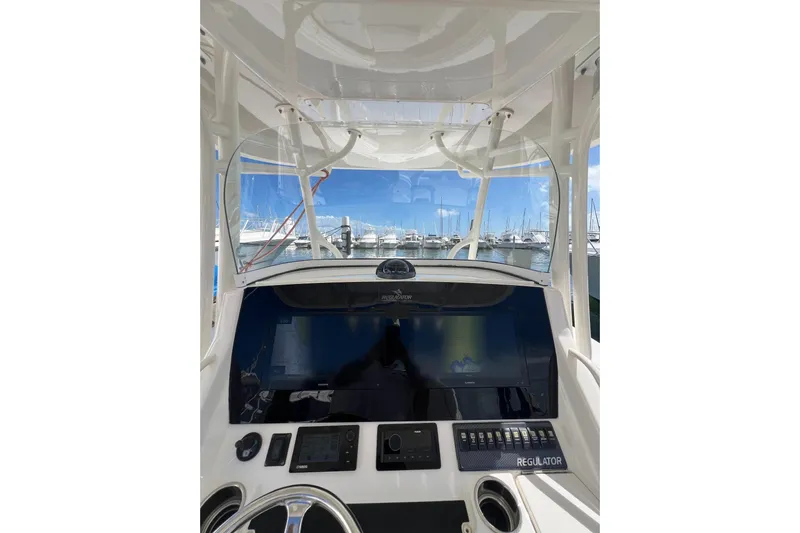 No Name Yacht Photos Pics 2016 Regulator 34 Center Console boat dashboard with marina view.