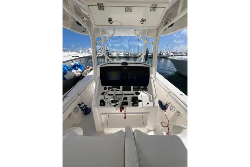 No Name Yacht Photos Pics 2016 Regulator 34 Center Console boat interior with steering wheel and navigation system.