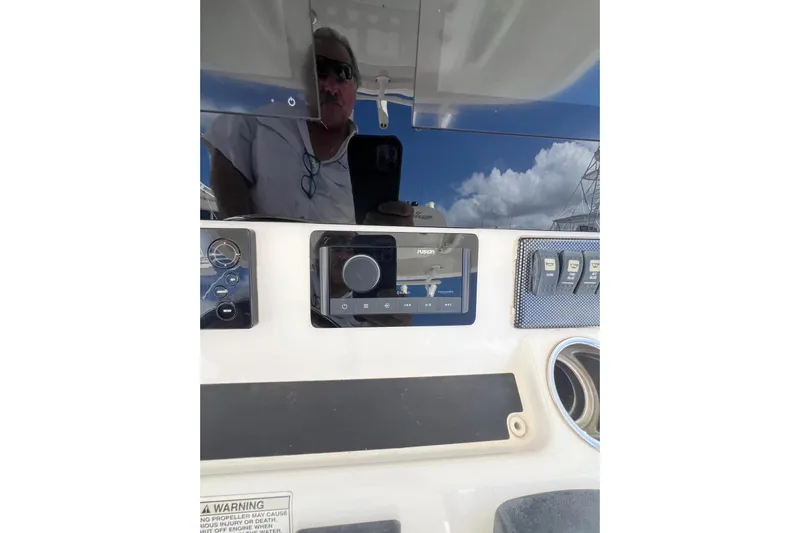 No Name Yacht Photos Pics 2016 Regulator 34 Center Console dashboard with controls and reflection.