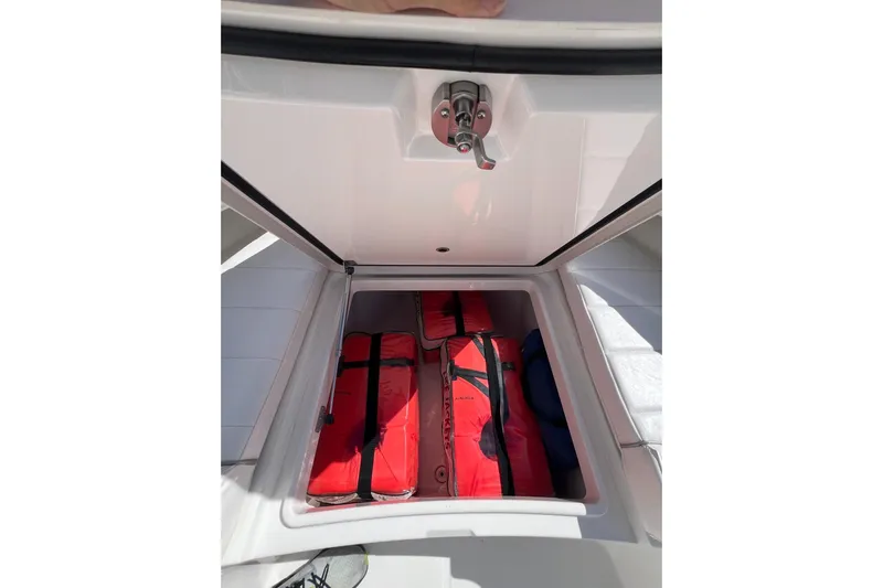 No Name Yacht Photos Pics Storage compartment on 2016 Regulator 34 Center Console with red life jackets.