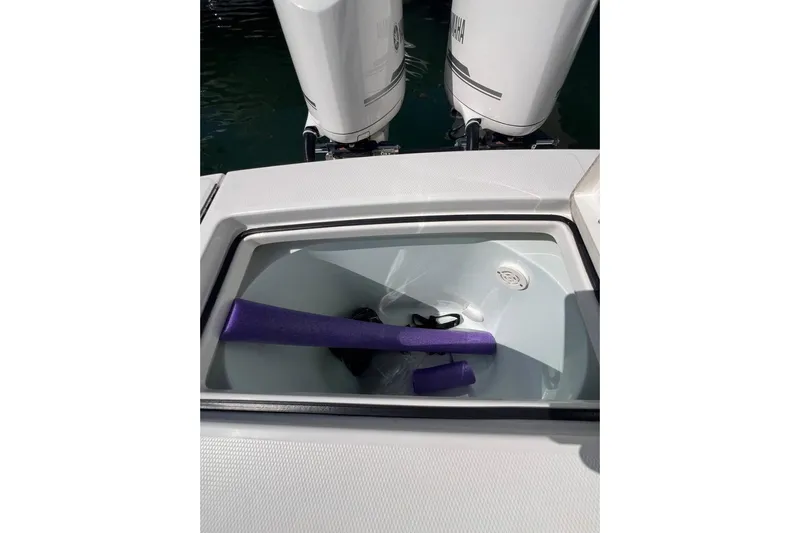 No Name Yacht Photos Pics 2016 Regulator 34 Center Console boat storage compartment with purple pool noodles.