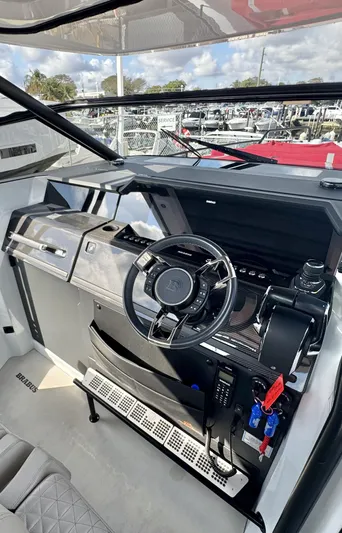 Kraken Yacht Photos Pics Cockpit of 2023 BRABUS Shadow 900 boat, featuring modern steering and control panel.