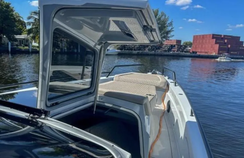 Kraken Yacht Photos Pics 2023 BRABUS Shadow 900 boat on a calm river with open cabin.