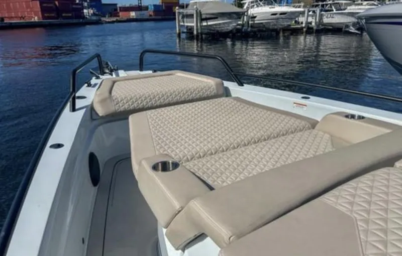 Kraken Yacht Photos Pics 2023 BRABUS Shadow 900 boat with luxurious beige seating on a calm waterfront.