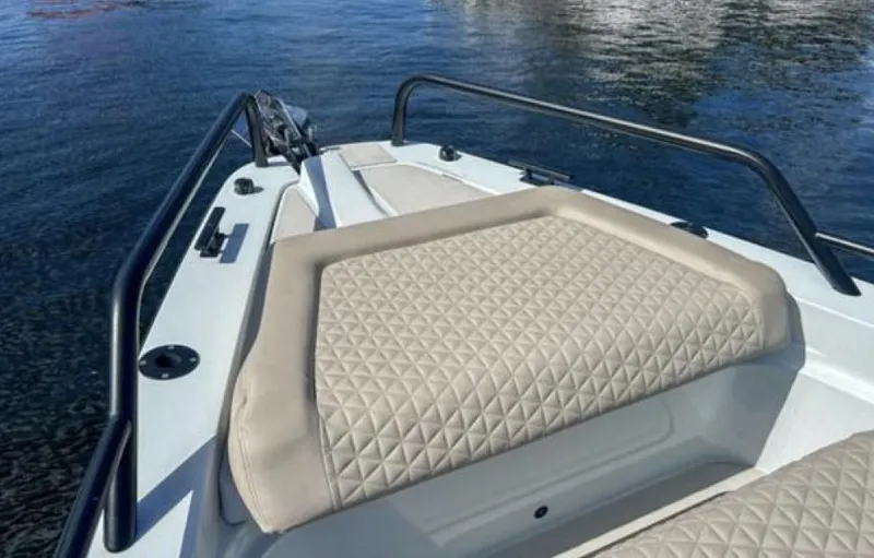 Kraken Yacht Photos Pics 2023 BRABUS Shadow 900 boat with beige quilted seating on calm water.