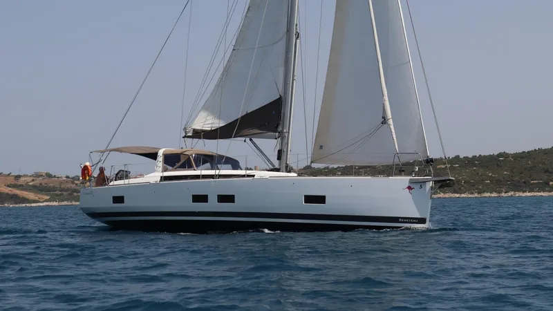 Nick Of Time III Yacht Photos Pics 2015 Beneteau Oceanis 55 sailing on open water, showcasing sleek design and spacious deck.