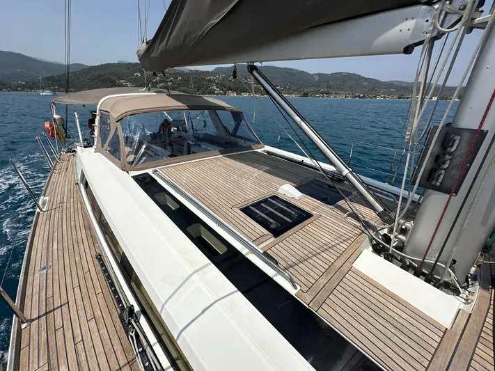 Nick Of Time III Yacht Photos Pics 2015 Beneteau Oceanis 55 sailboat on calm waters, featuring sleek deck design.