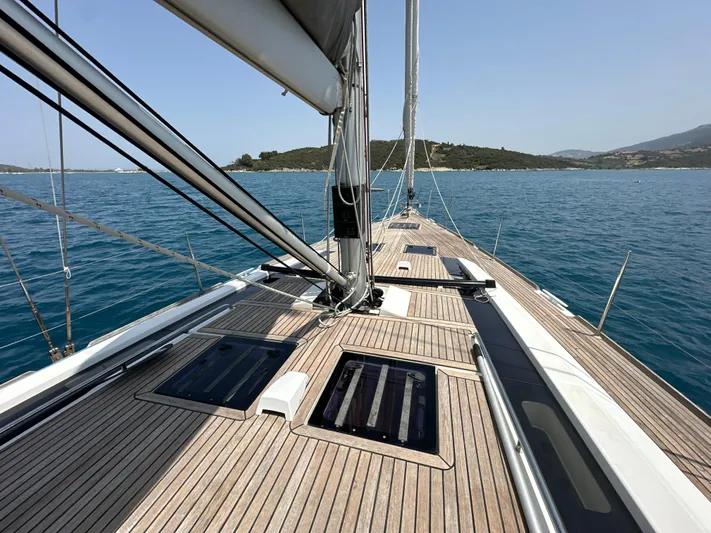 Nick Of Time III Yacht Photos Pics Beneteau Oceanis 55 sailboat deck, 2015 model, cruising on calm blue waters.