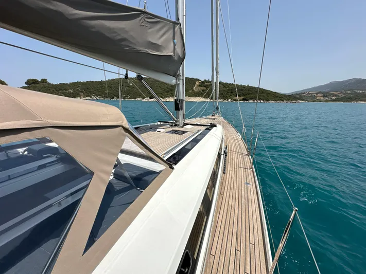 Nick Of Time III Yacht Photos Pics 2015 Beneteau Oceanis 55 sailboat on calm blue waters, showcasing sleek deck design.