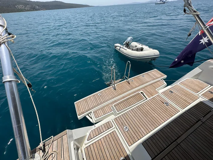 Nick Of Time III Yacht Photos Pics Beneteau Oceanis 55 yacht deck with dinghy on blue water, 2015 model.