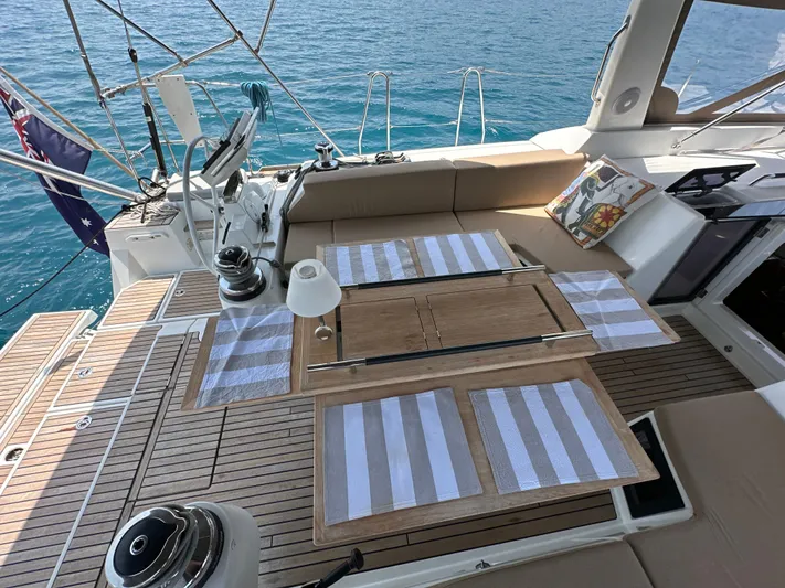 Nick Of Time III Yacht Photos Pics Luxurious 2015 Beneteau Oceanis 55 yacht deck with elegant dining setup and ocean view.