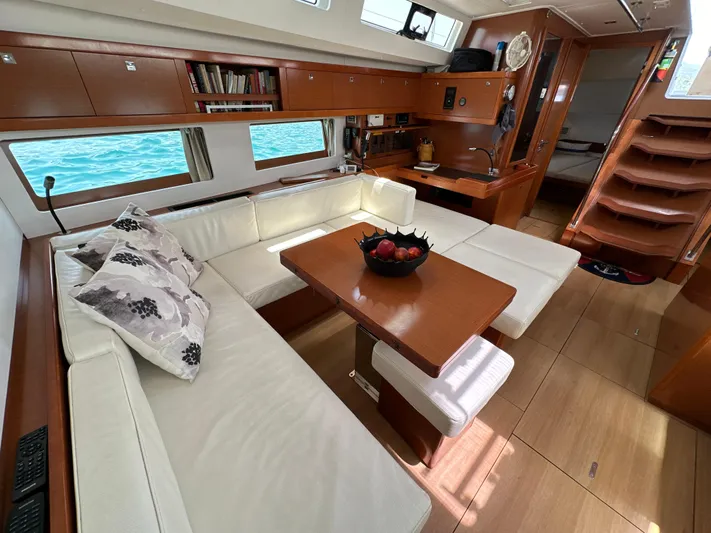 Nick Of Time III Yacht Photos Pics Luxurious interior of 2015 Beneteau Oceanis 55 yacht with elegant seating and wooden finishes.