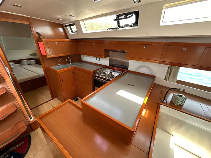 Nick Of Time III Yacht Photos Pics Interior of 2015 Beneteau Oceanis 55 yacht, featuring modern kitchen and cozy cabin.