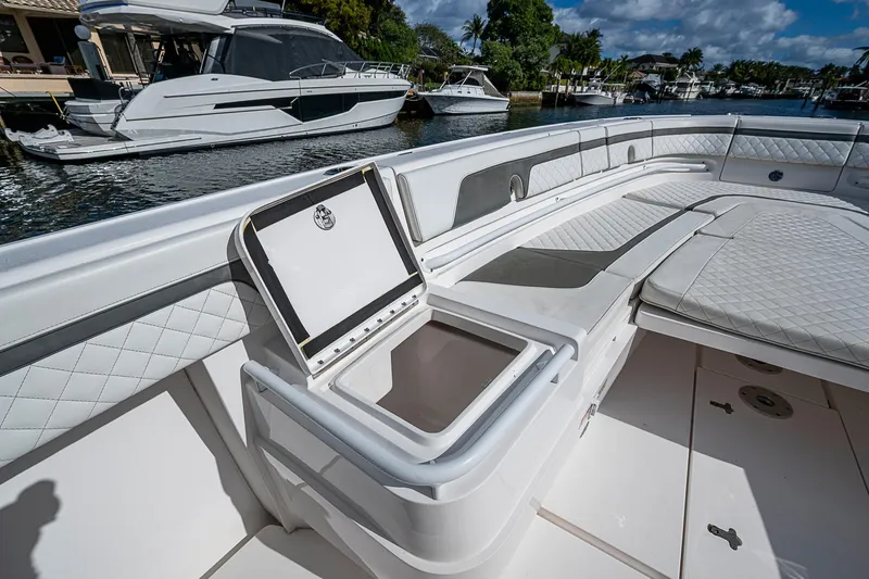  Yacht Photos Pics 2019 Intrepid 407 Nomad FE boat interior with open storage compartment, docked near other boats.