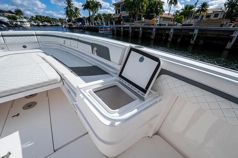  Yacht Photos Pics 2019 Intrepid 407 Nomad FE boat interior with seating and storage, dockside view.