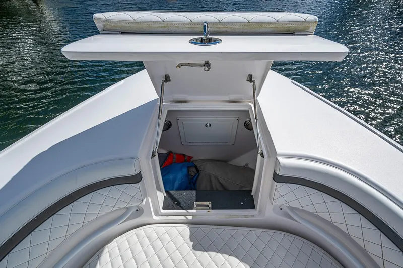  Yacht Photos Pics 2019 Intrepid 407 Nomad FE boat with open storage compartment and cushioned seating.