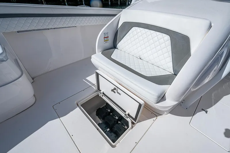  Yacht Photos Pics 2019 Intrepid 407 Nomad FE boat seat with storage compartment open.