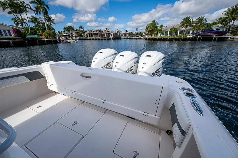  Yacht Photos Pics 2019 Intrepid 407 Nomad FE boat with triple engines, docked in a scenic waterfront area.