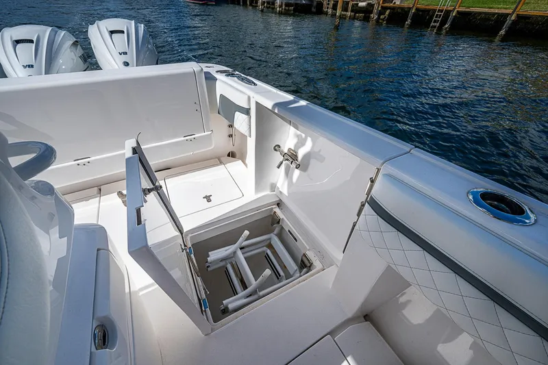  Yacht Photos Pics 2019 Intrepid 407 Nomad FE boat interior with open storage compartment and twin engines.