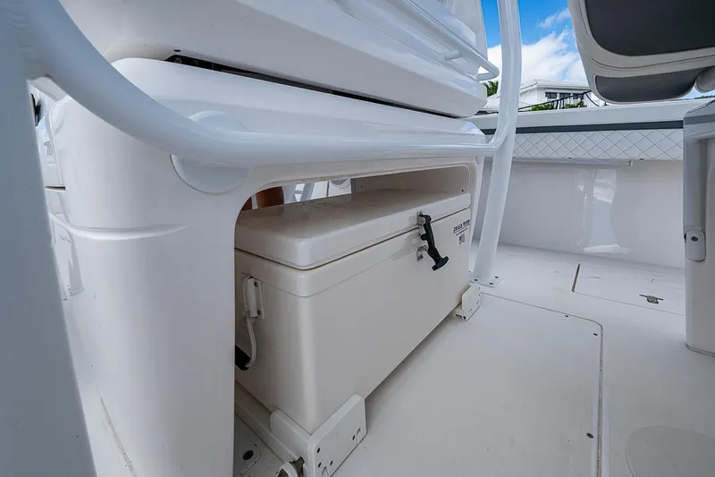  Yacht Photos Pics 2019 Intrepid 407 Nomad FE boat interior with storage compartment and cooler.