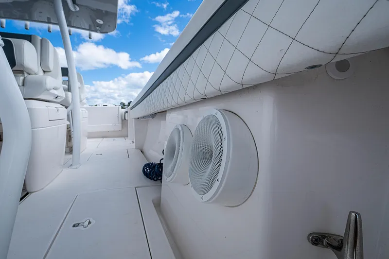  Yacht Photos Pics 2019 Intrepid 407 Nomad FE boat interior with speakers and seating under blue sky.