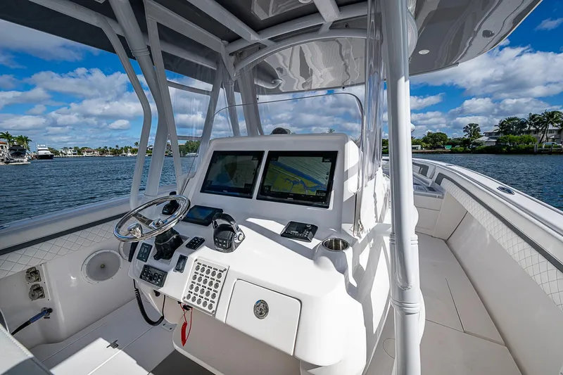  Yacht Photos Pics 2019 Intrepid 407 Nomad FE boat cockpit with navigation screens and steering wheel.