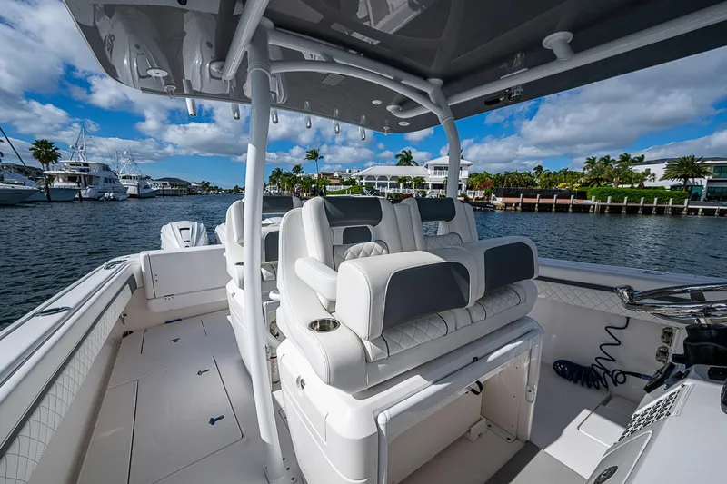  Yacht Photos Pics 2019 Intrepid 407 Nomad FE boat interior with luxurious seating, docked by waterfront homes.