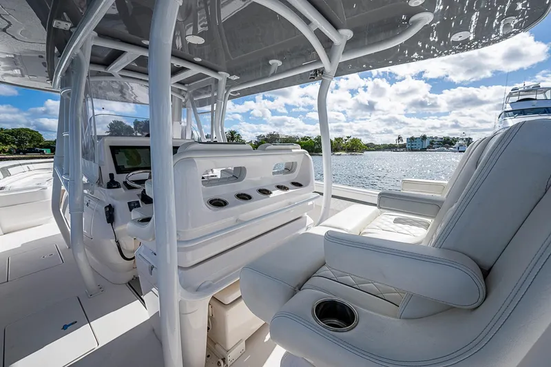  Yacht Photos Pics 2019 Intrepid 407 Nomad FE boat interior with luxurious seating and helm, overlooking serene waters.