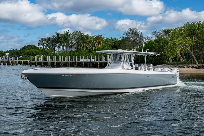  Yacht Photos Pics 2019 Intrepid 407 Nomad FE boat cruising near a tropical shoreline.