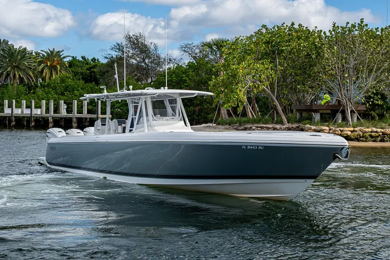  Yacht Photos Pics 2019 Intrepid 407 Nomad FE boat cruising near lush shoreline.