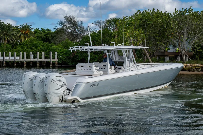  Yacht Photos Pics 2019 Intrepid 407 Nomad FE boat cruising on water with triple outboard engines.
