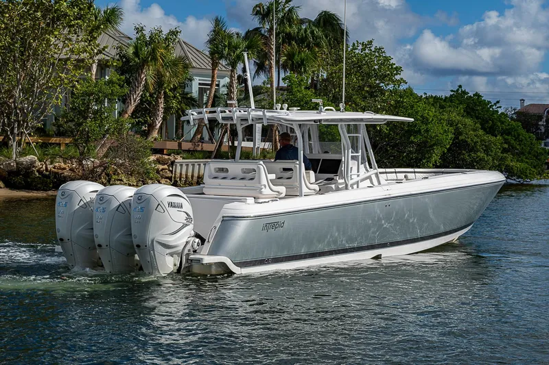  Yacht Photos Pics 2019 Intrepid 407 Nomad FE boat cruising on water with triple Yamaha engines.