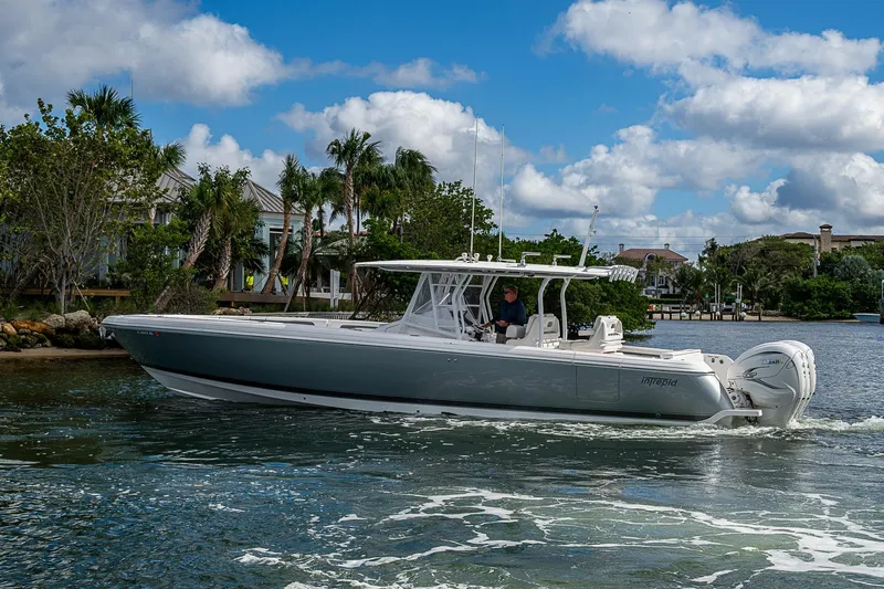  Yacht Photos Pics 2019 Intrepid 407 Nomad FE boat cruising on a sunny day with palm trees in the background.