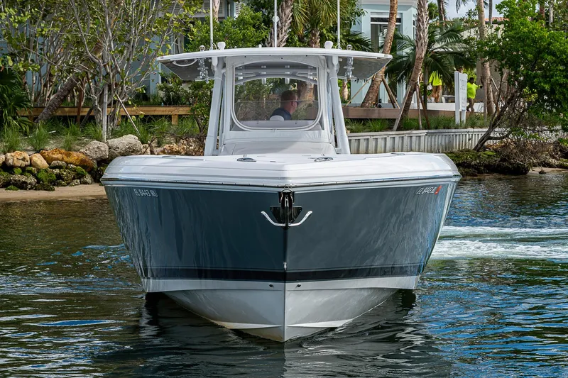  Yacht Photos Pics 2019 Intrepid 407 Nomad FE boat cruising near a tropical shoreline.