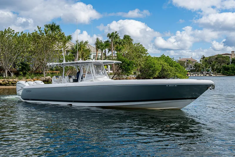  Yacht Photos Pics 2019 Intrepid 407 Nomad FE boat cruising on a scenic waterway with lush greenery.