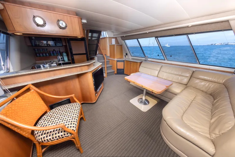 Adventures Await Yacht Photos Pics Luxurious interior of 2004 Meridian 490 Pilothouse yacht with leather seating and ocean view.