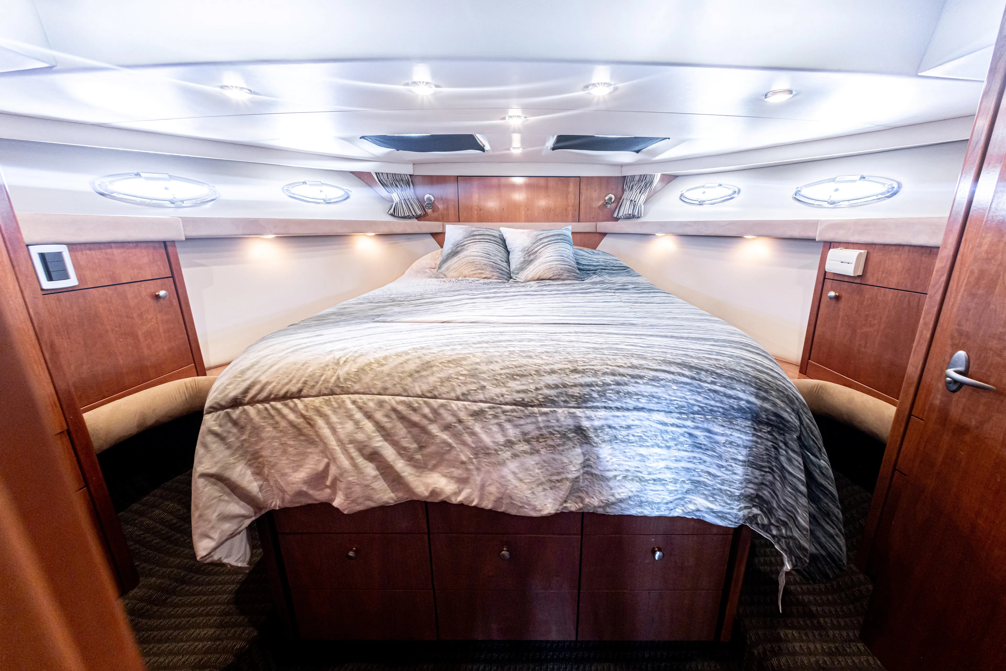 Adventures Await Yacht Photos Pics Luxurious bedroom interior of 2004 Meridian 490 Pilothouse yacht with cozy bedding.