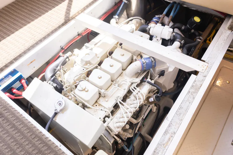 Adventures Await Yacht Photos Pics Engine compartment of a 2004 Meridian 490 Pilothouse yacht, showcasing detailed mechanical components.