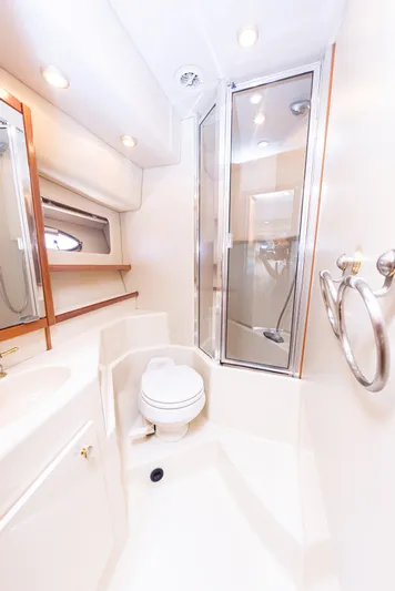 Adventures Await Yacht Photos Pics 2004 Meridian 490 Pilothouse bathroom with shower, toilet, and mirror.