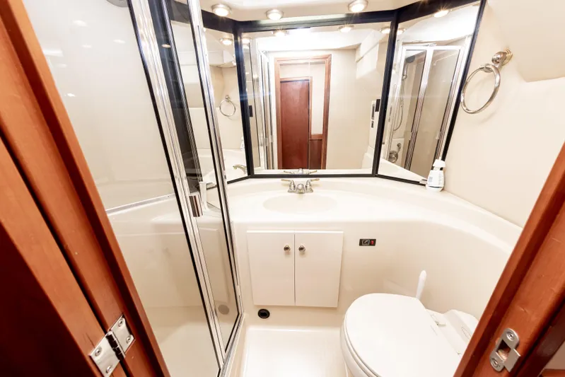 Adventures Await Yacht Photos Pics Bathroom interior of 2004 Meridian 490 Pilothouse yacht with shower and vanity.