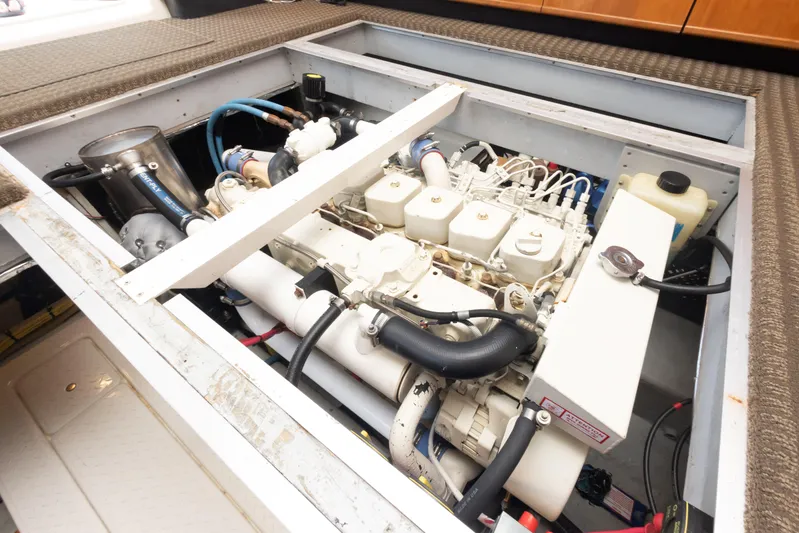 Adventures Await Yacht Photos Pics Engine compartment of a 2004 Meridian 490 Pilothouse yacht, showcasing mechanical components.